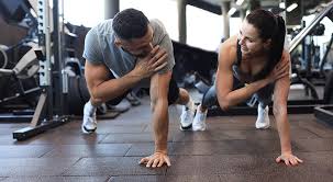 Image of man and woman doing Cardio Bedford to tone their arms. 